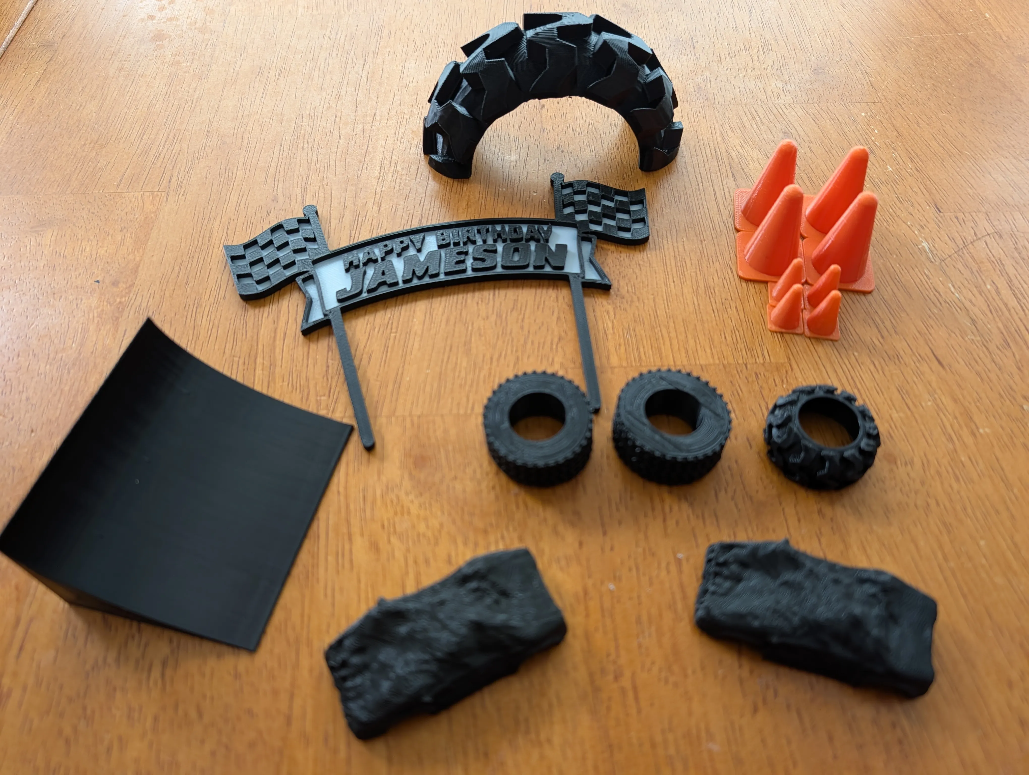 A 3D printed monster truck birthday cake toppers